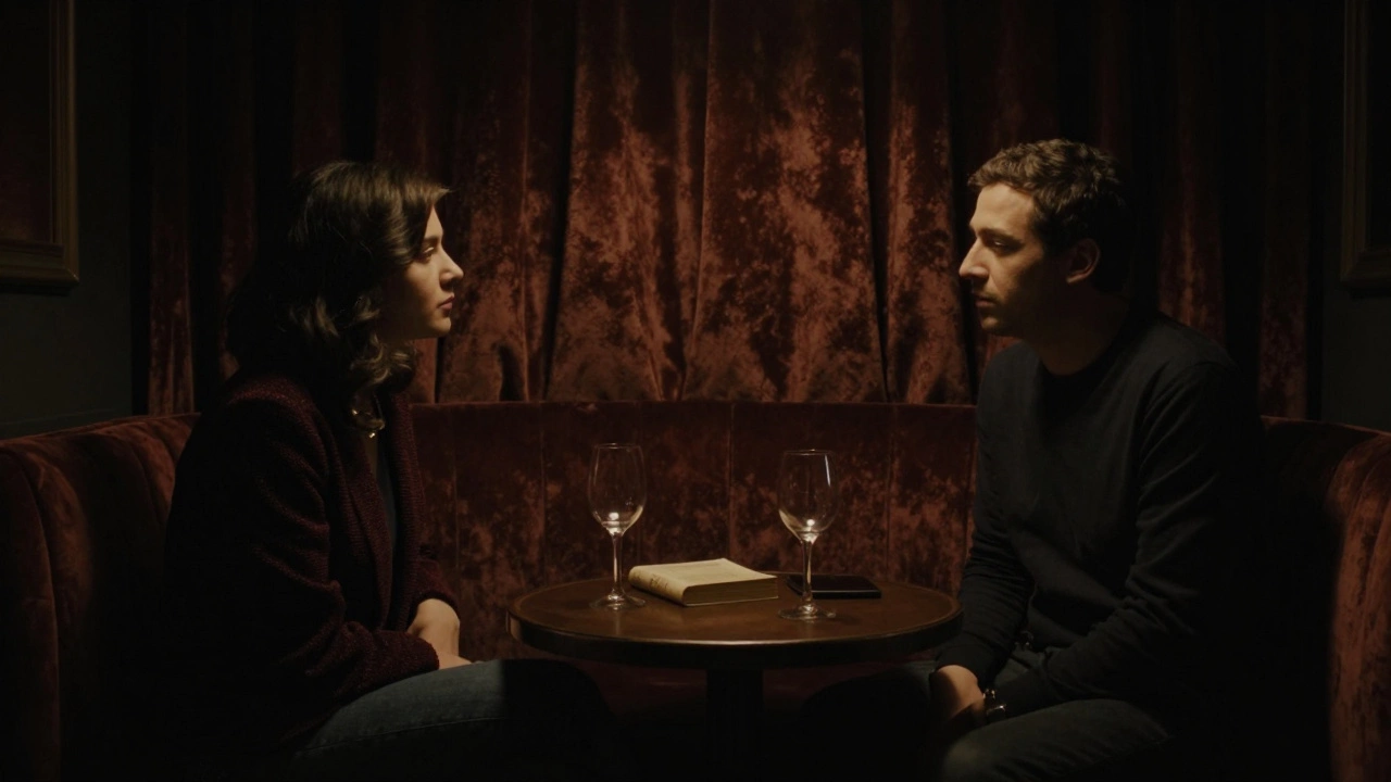 Two people sit in silence in a dimly lit private lounge, sharing a quiet moment of emotional connection.